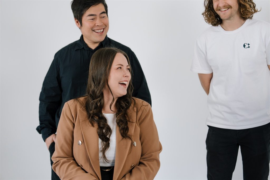 one x team laughing together